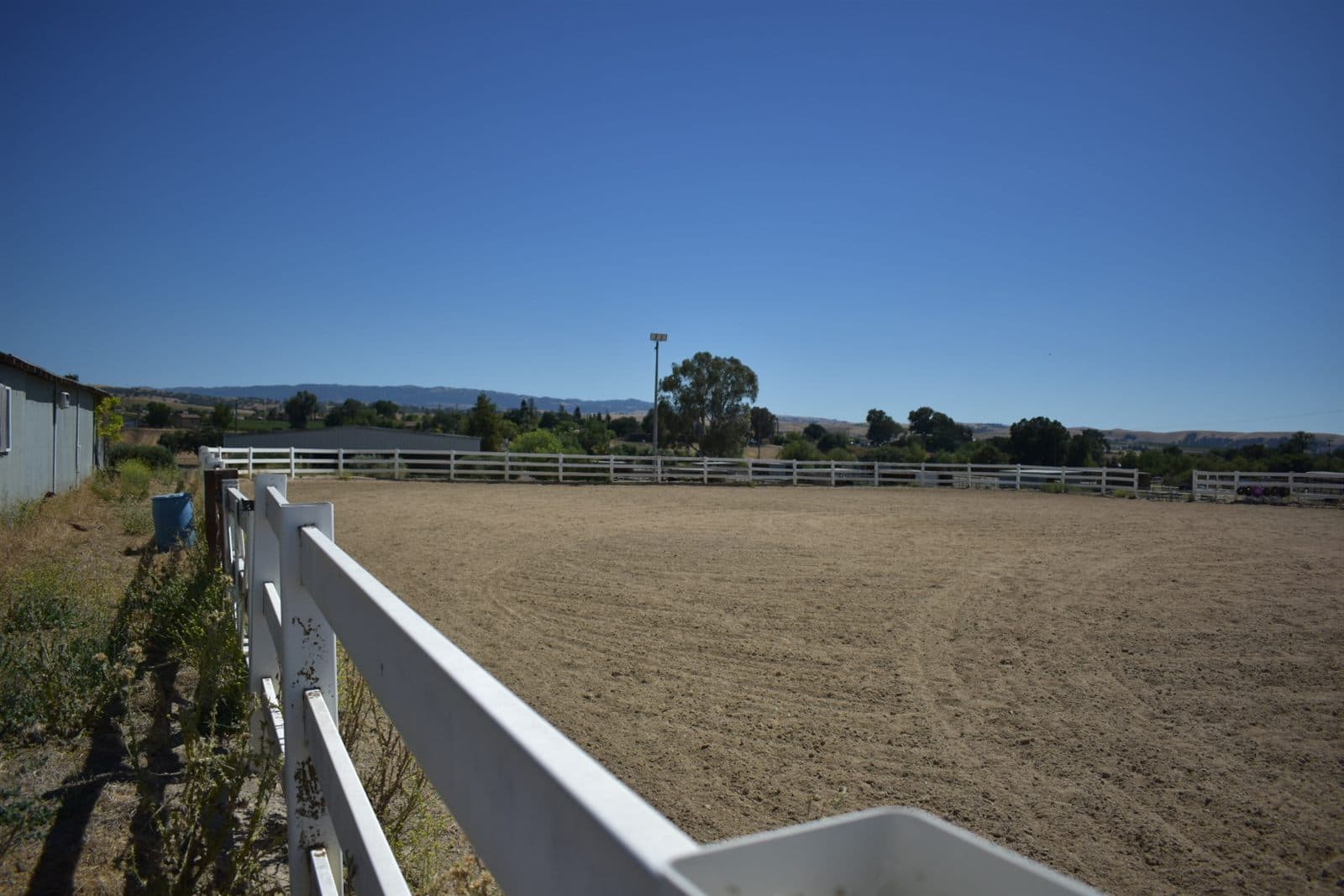 The outdoor sand arena with mountain views
