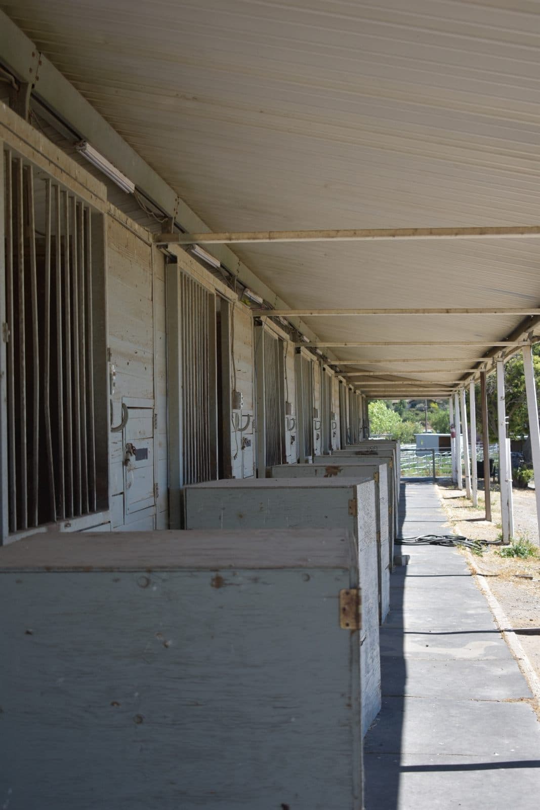 The covered stall aisle running the length of the barn